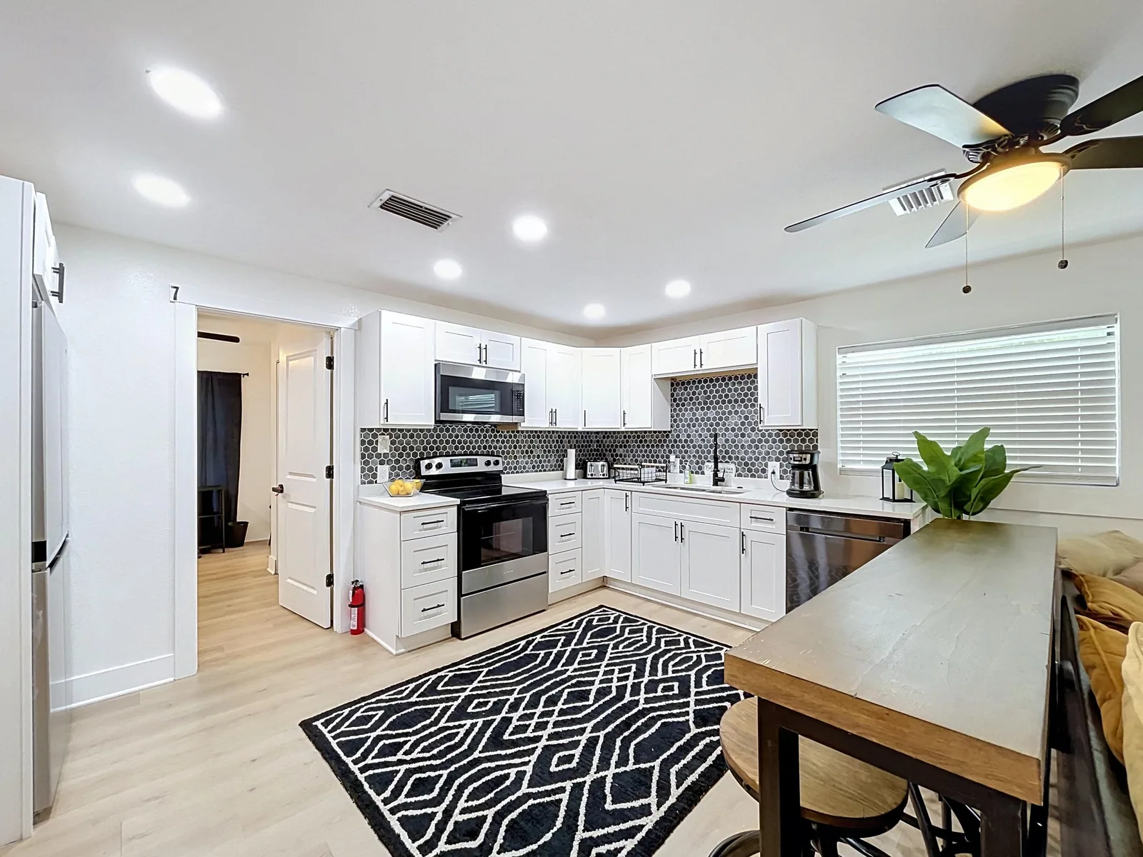 Kitchen with an island and bar seating in an Avenir-managed co-living property