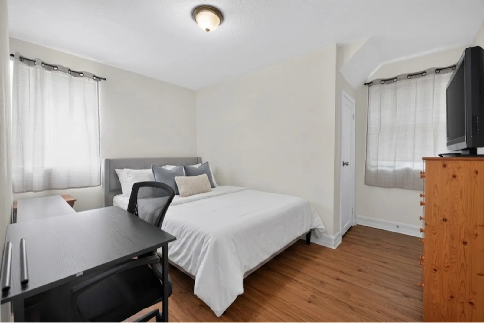 Furnished bedroom with a desk and chair in an Avenir-managed co-living property